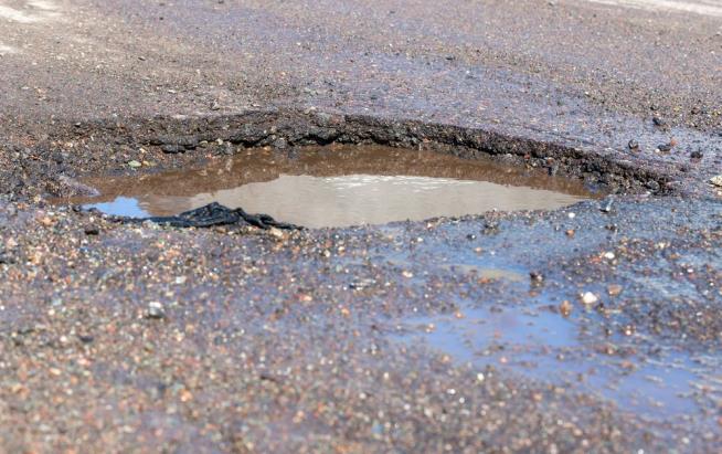 Frustrated Man Hosts Birthday Party for Neighborhood Pothole