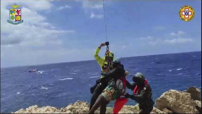 Italian Rescuers Save Migrants Clinging to Reef