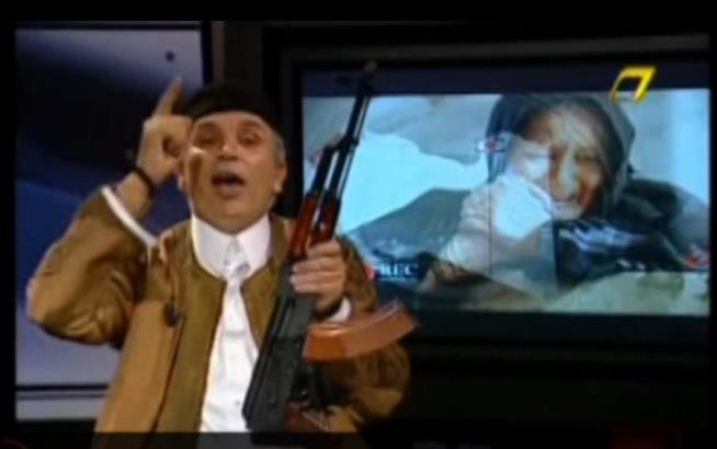 Gun-Toting News Anchor Vows to Defend Gadhafi