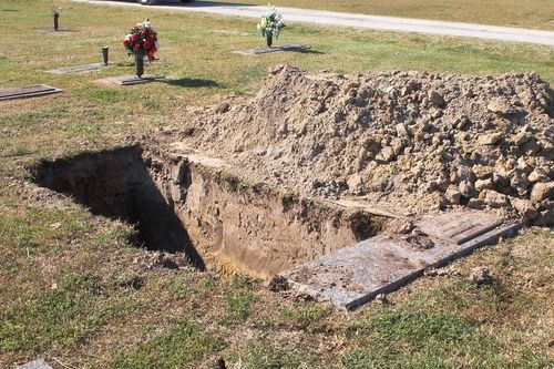 Cemetery Worker Breaks Legs Falling Into Grave