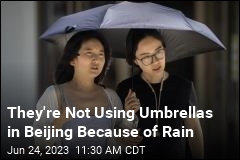 They&#39;re Not Using Umbrellas in Beijing Because of Rain