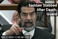 Saddam Stabbed After Death: Guard