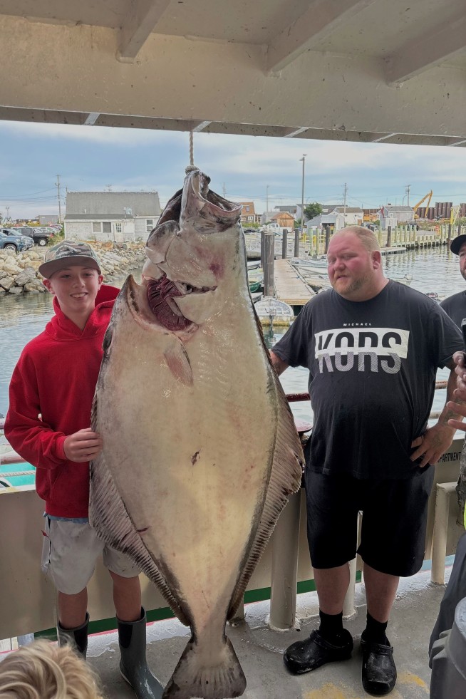 Young man and the sea: Teen fishing off New England coast catches huge halibut bigger than him