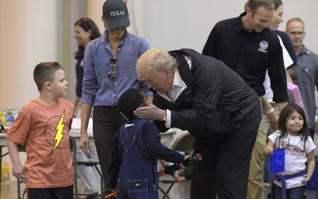 Trump pitches in at shelter for Harvey victims