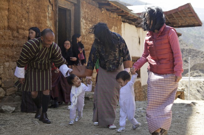 Conjoined twins back in Bhutan after separation in Australia