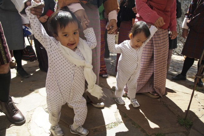 Conjoined twins back in Bhutan after separation in Australia