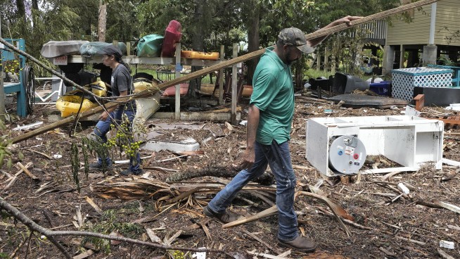 Residents pick through the rubble of lost homes and scattered belongings in Hurricane Idalia's wake