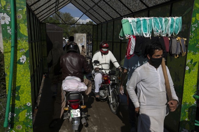 The Latest: Russian police detain activists delivering gear