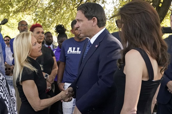Florida Gov. Ron DeSantis booed at vigil as hundreds mourn more racist killings