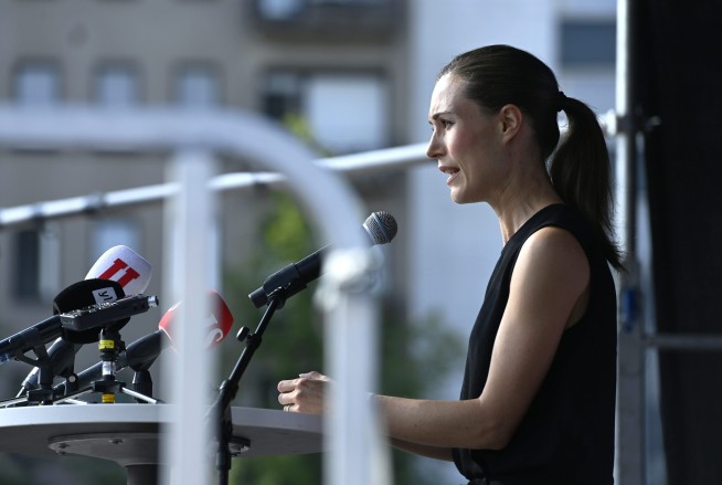 Finland's leader apologizes for party photo at summer home