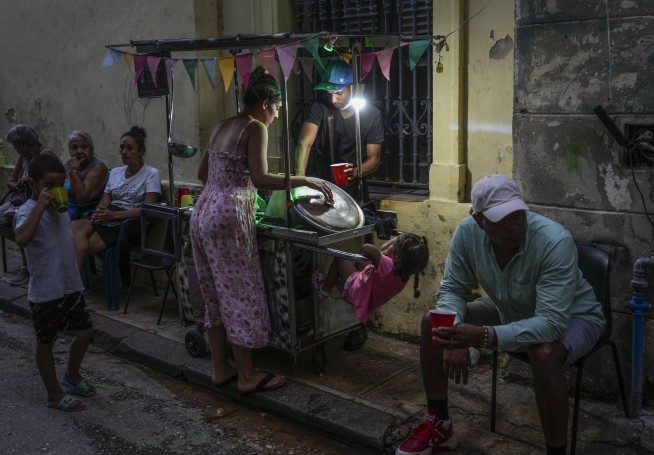Cuba fights to come back from a nationwide blackout, then a storm that killed six