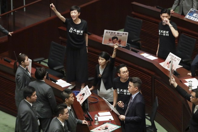 The Latest: Protest again stops Hong Kong leader's speech