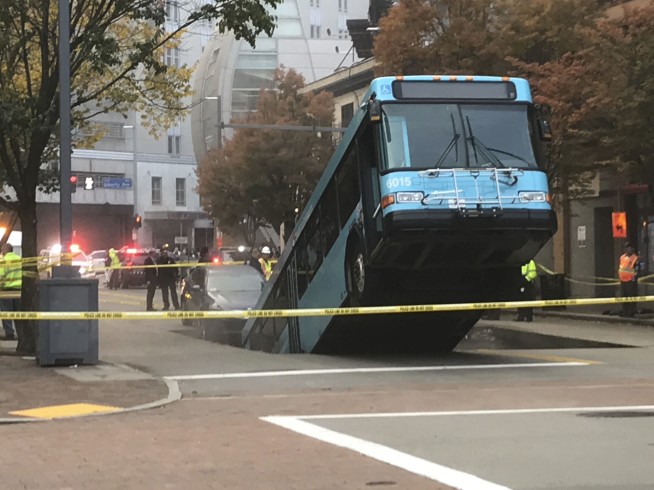 Sinkhole opens, swallows part of city bus during rush hour