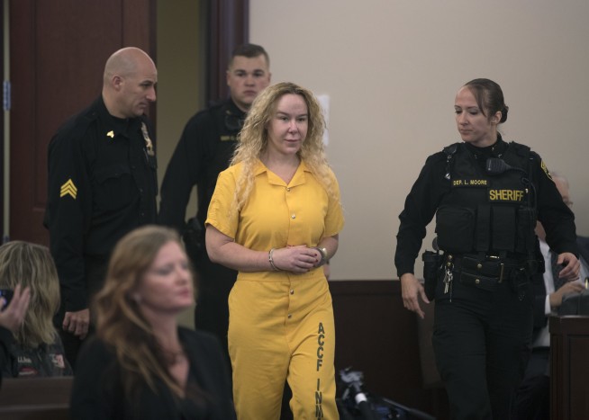 Woman arrested in twin's death off cliff fights extradition