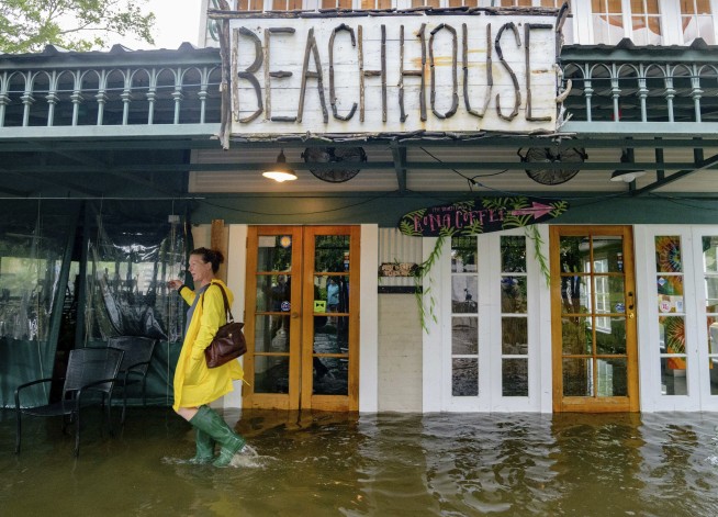 Barry crawls ashore in Louisiana, weakens to tropical storm