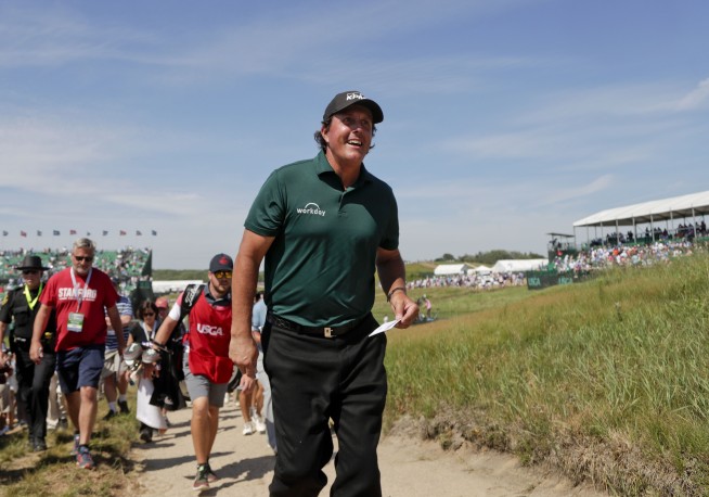 Mickelson penalized for swatting moving ball with putter
