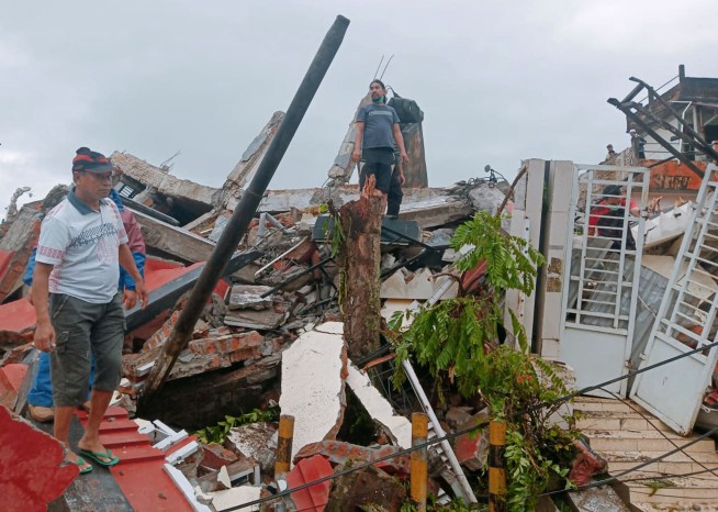 At least 34 dead as Indonesia quake topples homes, buildings