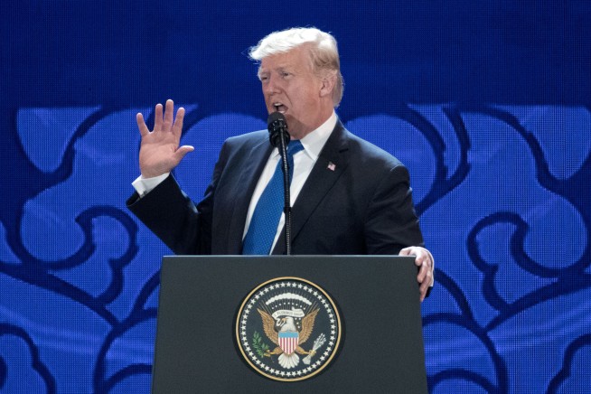 The Latest: Trump, Putin shake hands at summit in Vietnam