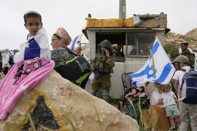In mass rally, Israeli settlers march to West Bank outpost
