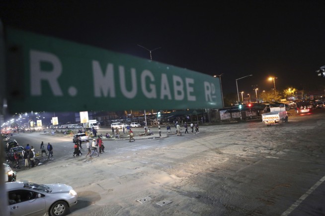 Zimbabwe army controls broadcaster, says Mugabe, wife safe