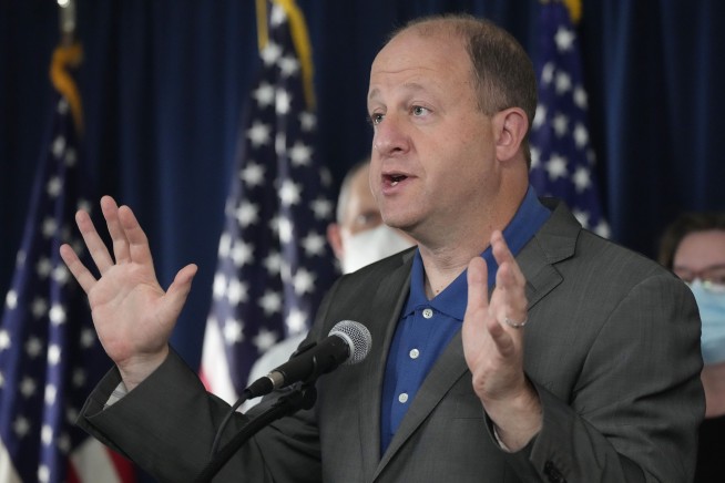 Colorado governor says all adults can get COVID booster shot