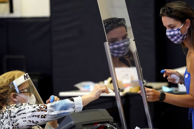 States reverse openings, require masks amid virus resurgence