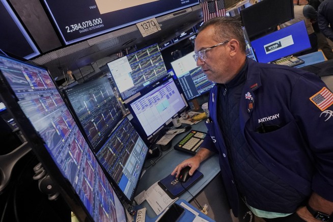 Wall Street edges back from its record heights