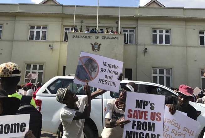 The Latest: Zimbabwe erupts with Mugabe's resignation