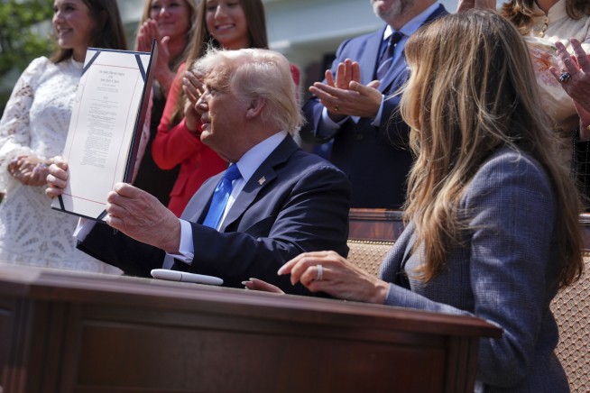 Trump signs a bill to make posting 'revenge porn' a federal crime. He had the first lady sign, too