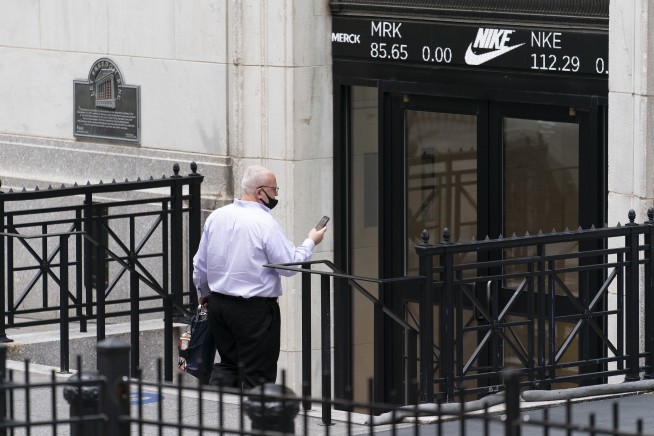 Stocks end a bumpy day mostly lower, still notch August gain