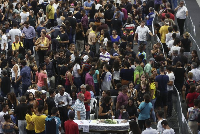 Brazil says goodbye to shooting victims, questions mount