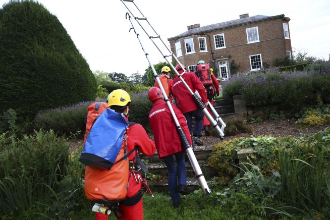 Greenpeace demonstrators drape UK prime minister's house in black to protest oil expansion
