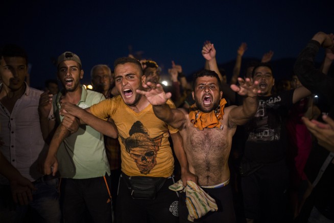 The Latest: Pope Francis asks faithful to shelter refugees