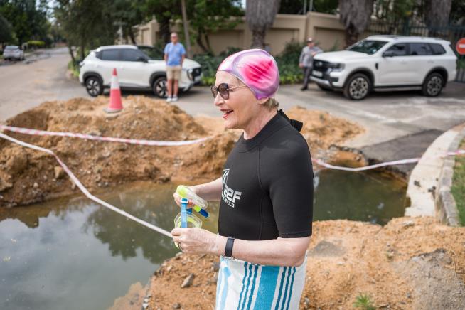 A South African politician goes snorkeling in a giant pothole to highlight city management failures