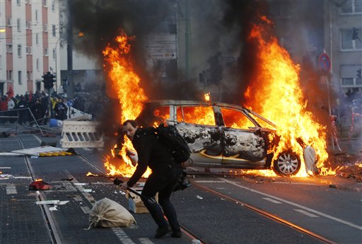 Police cars set alight at austerity protest in Germany