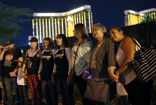 Dimmed lights, somber tributes on Vegas shooting anniversary