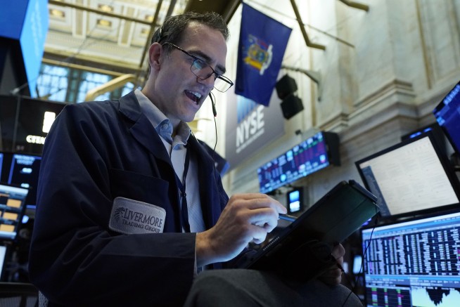 S&P 500 clings to a modest gain as other indexes end mixed