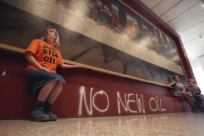 UK climate protesters glue themselves to gallery paintings
