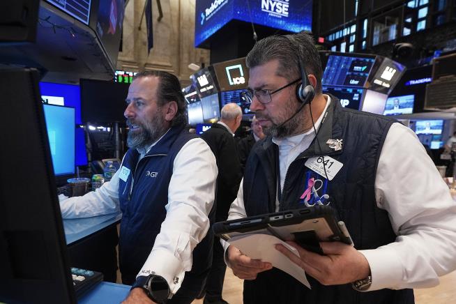 Stocks edge a bit below their latest records on Wall Street
