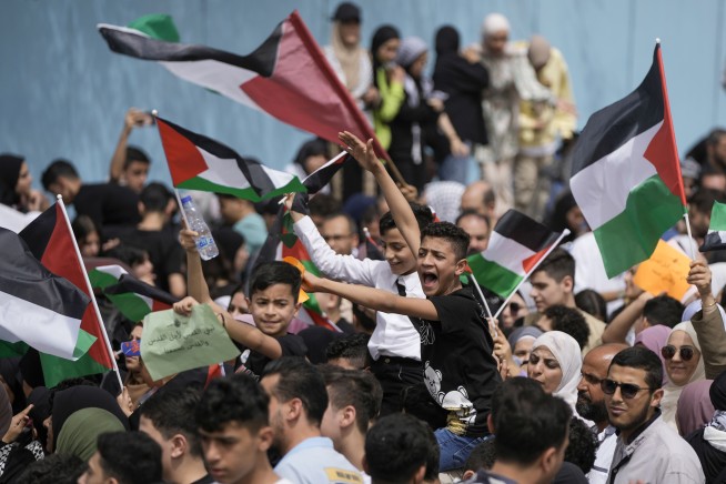 The Latest | Iran says air defense batteries fire after explosions reported near major air base