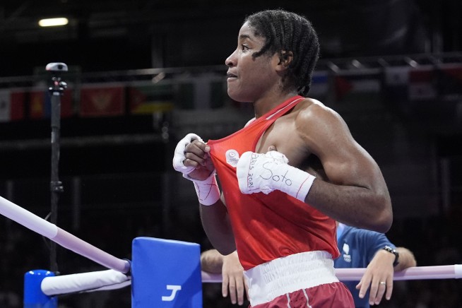 Boxer Cindy Ngamba becomes first athlete competing as a refugee to clinch an Olympic medal