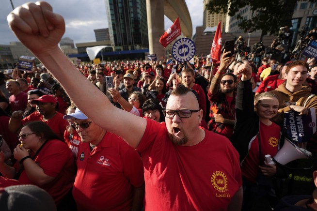 Workers strike at all 3 Detroit automakers, a new tactic to squeeze companies for better pay
