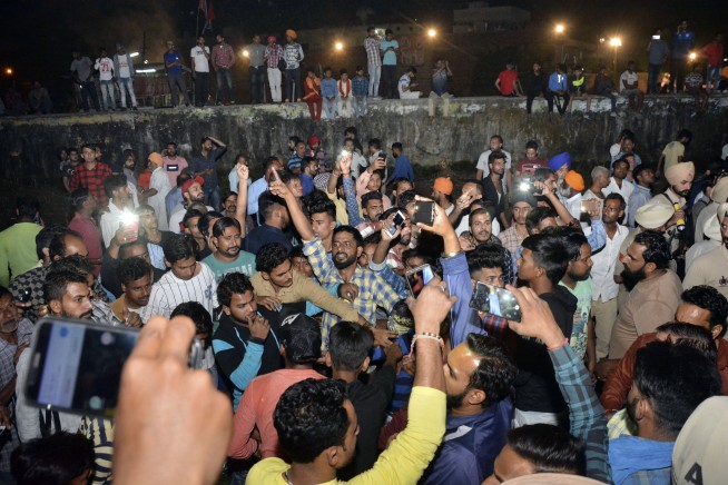 Train mows down crowd at India festival, at least 60 dead