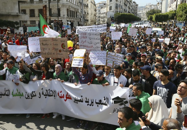 The Latest: Algerians celebrate news that Bouteflika quits