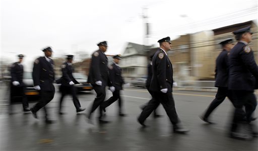 Mayor eulogizes officer as cops outside turn backs