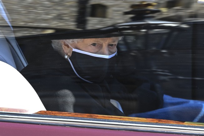 Prince Philip is laid to rest as somber queen sits alone