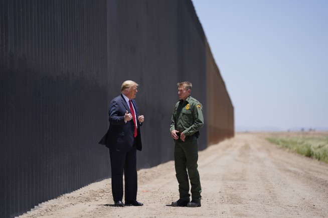 As virus surges, Trump turns attention to border wall