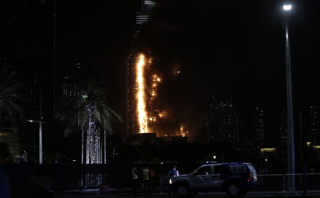 Dubai New Year fireworks kick off while nearby tower blazes