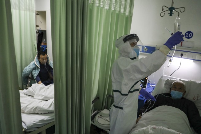 China's virus death toll surpasses SARS but new cases fall