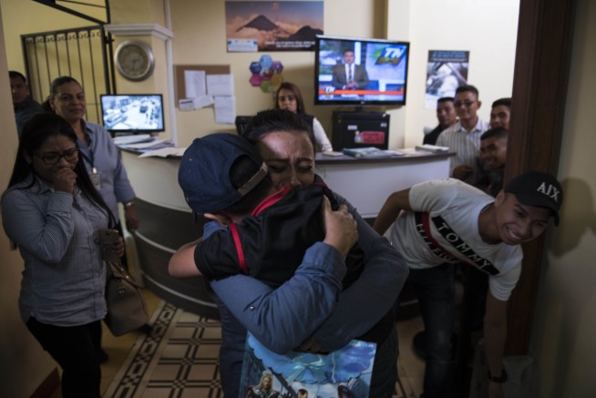 Tearful reunions for 9 separated kids back in Guatemala